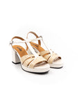 Beige and white heeled sandals.
