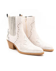 A white ankle boot with a heel, featuring a side zipper and decorative stitching detail.