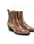 Gold metallic ankle boot on a white background
