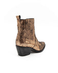 Gold metallic ankle boot on a white background