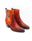 Boot with orange side panel on a white background