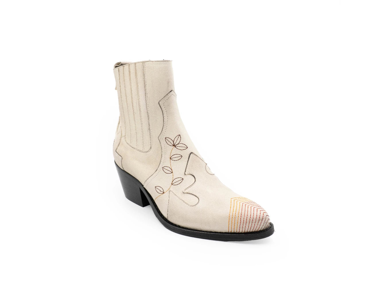 White cowboy boot with black embroidery on a white background