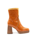 Orange ankle boot with wooden block heel on a white background