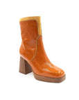 Orange ankle boot with a block heel on a white background