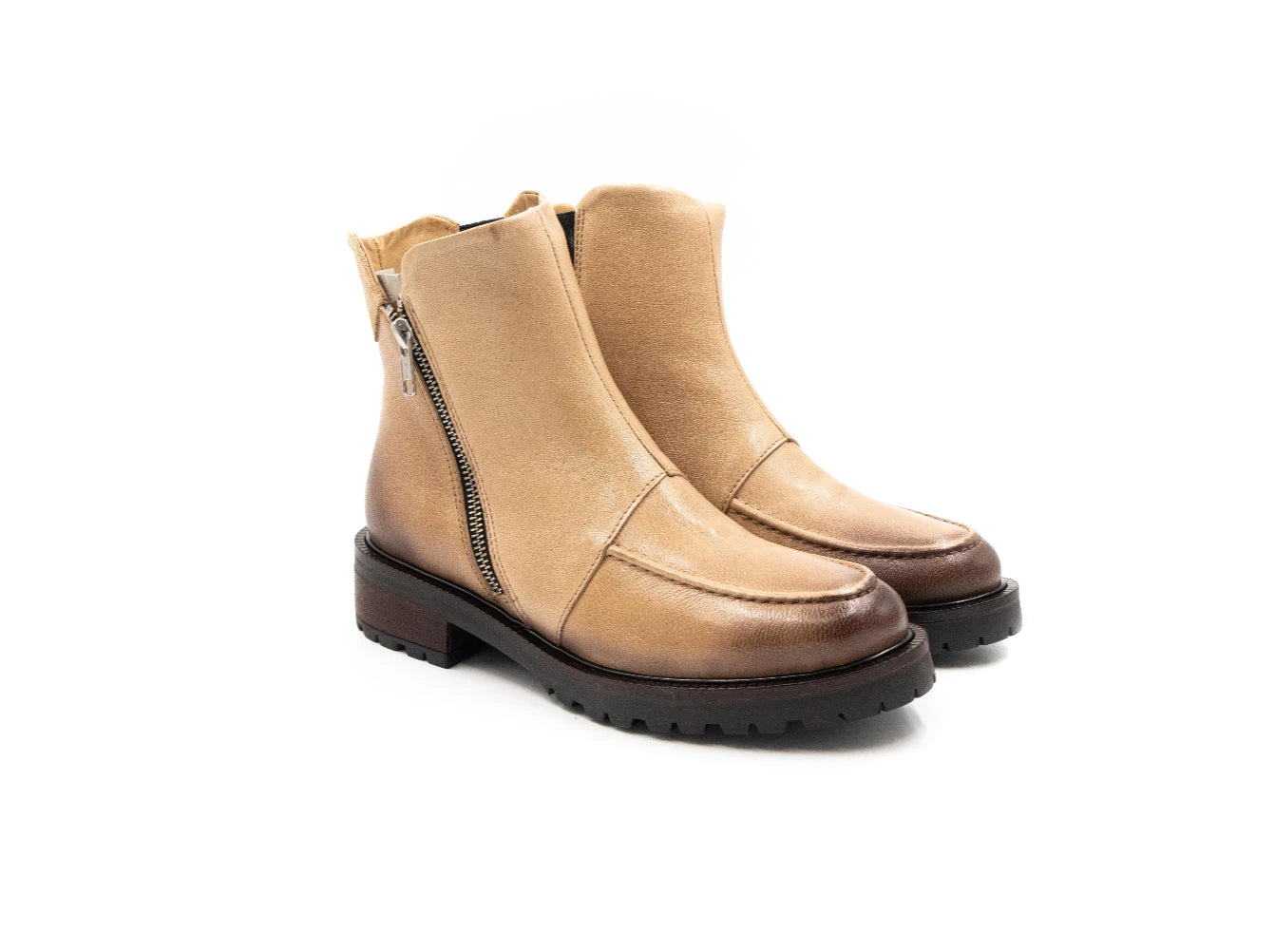 Pair of tan boots with zippers on a white background