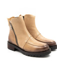 Pair of tan boots with zippers on a white background