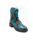 Blue leather boot with brown accents on a white background