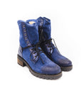 Pair of blue suede boots with black laces on a white background