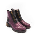 Pair of purple leather boots with zippers on a white background