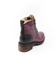 Purple ankle boot with black sole on a white background