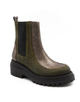 Green Chelsea boot with black sole on a white background