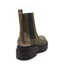 Green Chelsea boot with glittery side panel on a white background