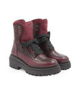 Pair of maroon boots with black soles on a white background