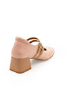 A pink Mary Jane style heel with a squared toe and buckle strap.