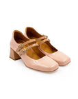 A pink Mary Jane style heel with a squared toe and buckle strap.