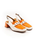 A white and orange two-tone patent leather moccasin style heel with an adjustable back strap.