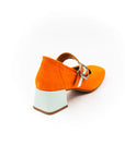 A bright orange Mary Jane style shoe with a squared toe and a 4cm heel, featuring a white buckle and a removable insole.