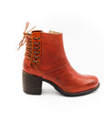 Brown leather boot with a block heel on a white background