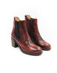 Pair of brown leather ankle boots on a white background