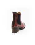 Brown leather boot with a wooden sole on a white background