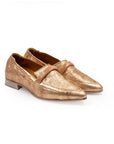 Pair of gold loafers on a white background