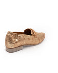 Bronze slip-on shoe on a white background