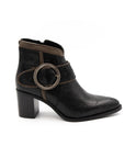 Black ankle boot with circular design on a white background