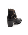 Black boot with decorative buckle on a white background