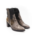 Pair of brown suede ankle boots with black accents on a white background