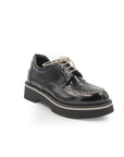 Black leather shoe with a platform sole on a white background