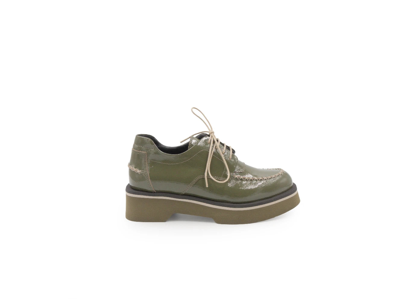 Green leather shoe with a platform sole on a white background