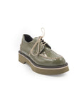 Green leather shoe with a thick sole on a white background