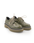 Pair of green leather shoes on a white background
