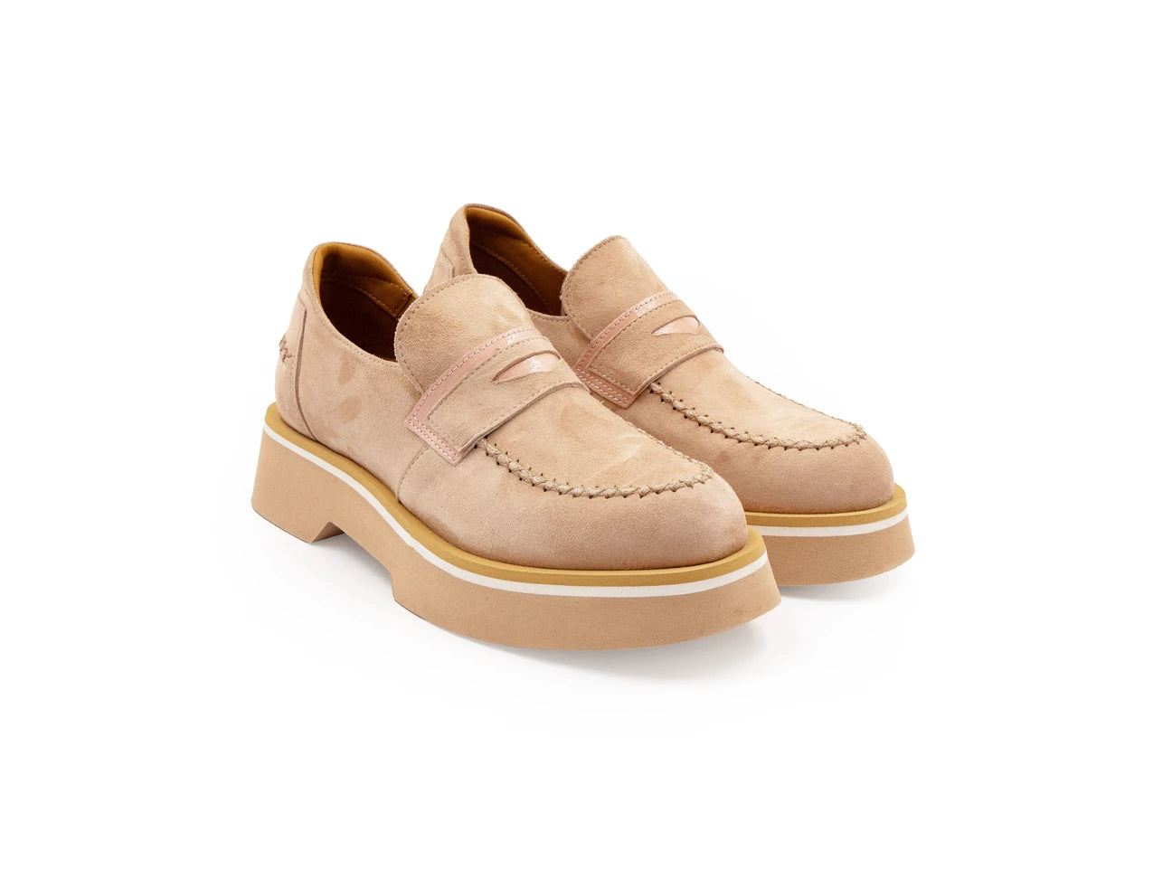 A beige suede loafer with a contrast color sole.