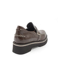 Brown patent leather shoe on a white background