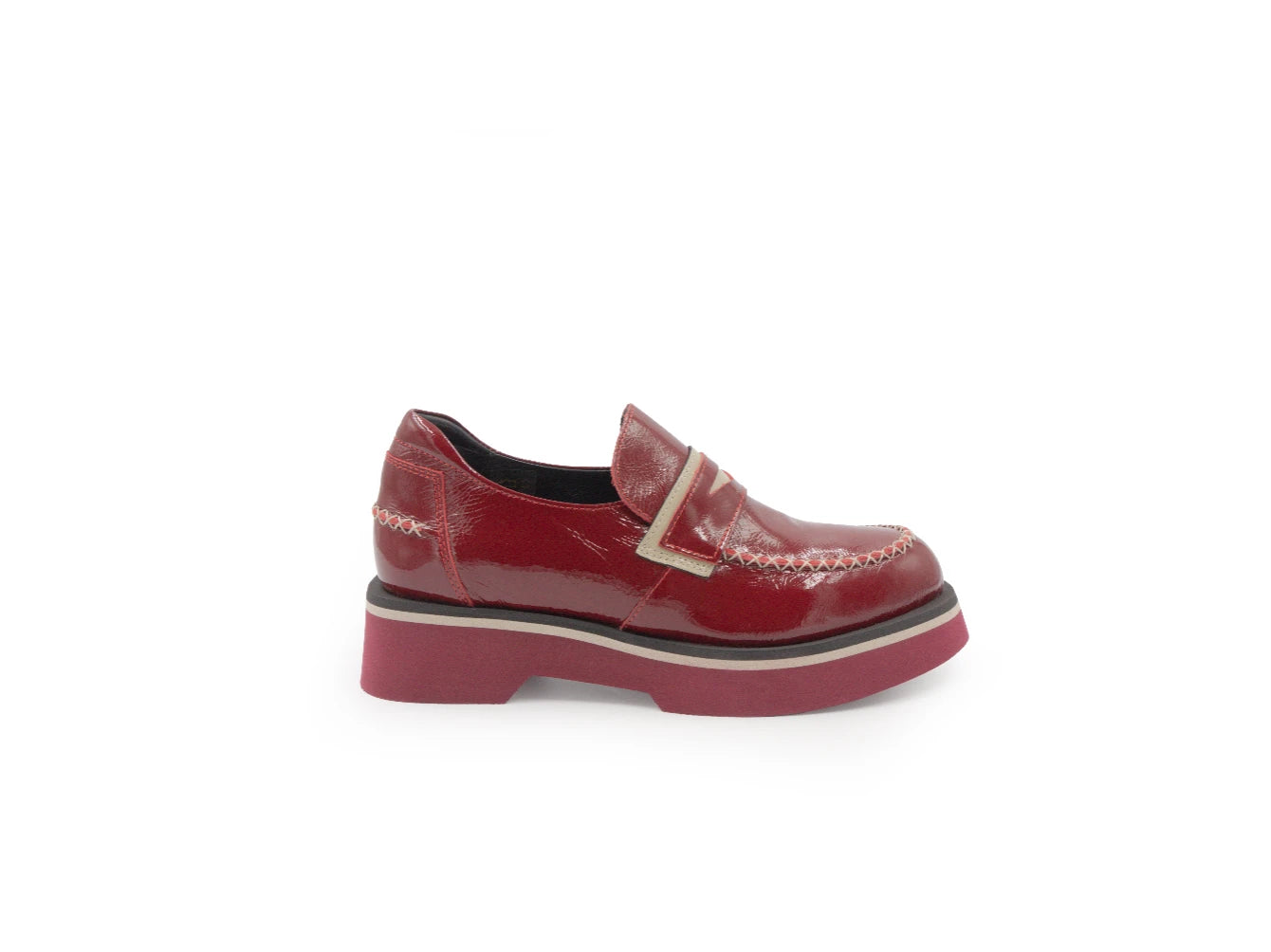 Red patent leather loafer on a white background