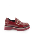 Red patent leather loafer on a white background