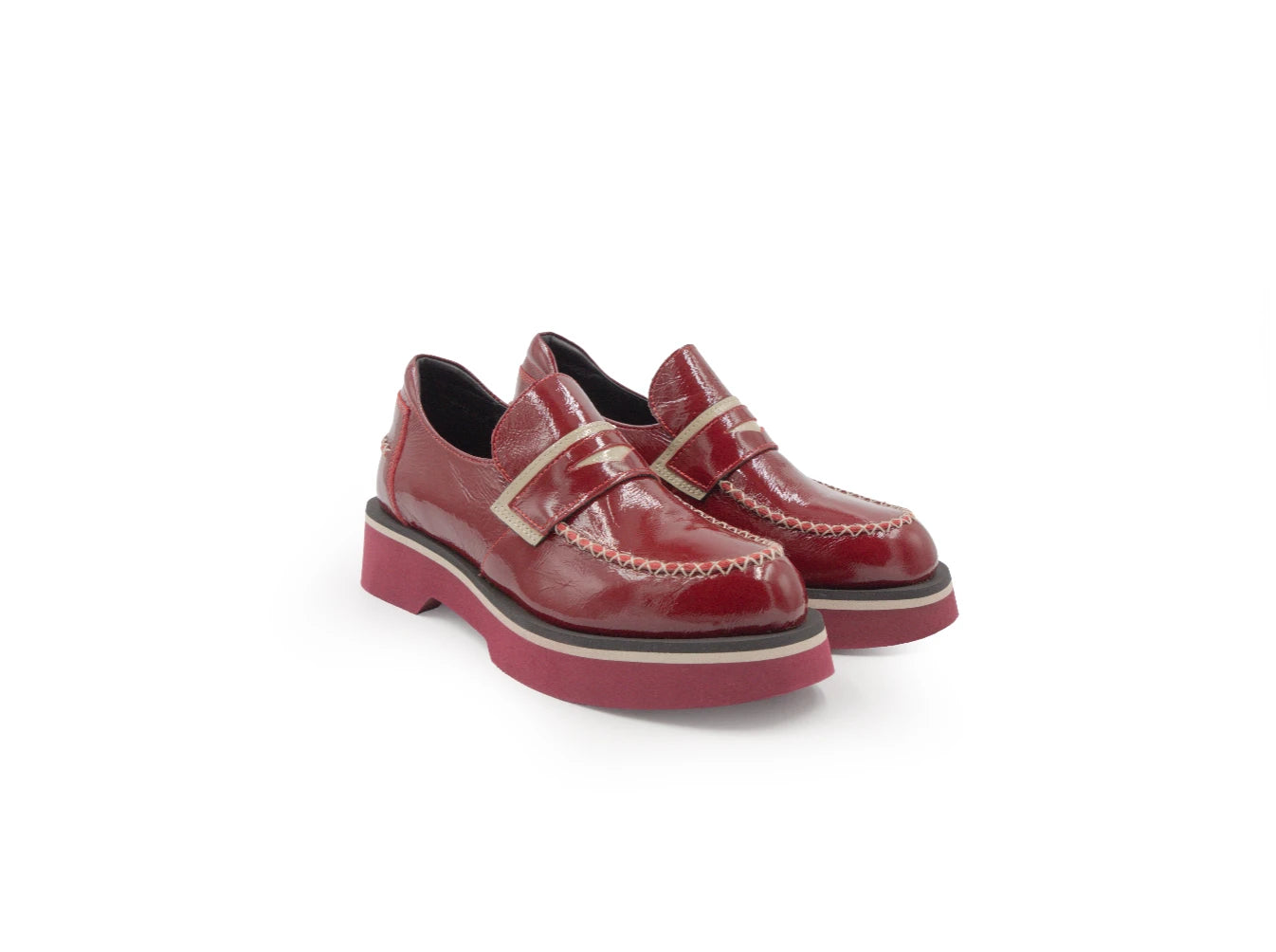 Pair of red loafers on a white background