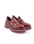 Pair of red loafers on a white background
