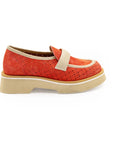 A red flat shoe with a white strap and a beige sole, designed for women.