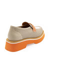 A beige and orange flat shoe with a perforated upper and a solid orange sole.