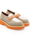 A beige and orange flat shoe with a perforated upper and a solid orange sole.