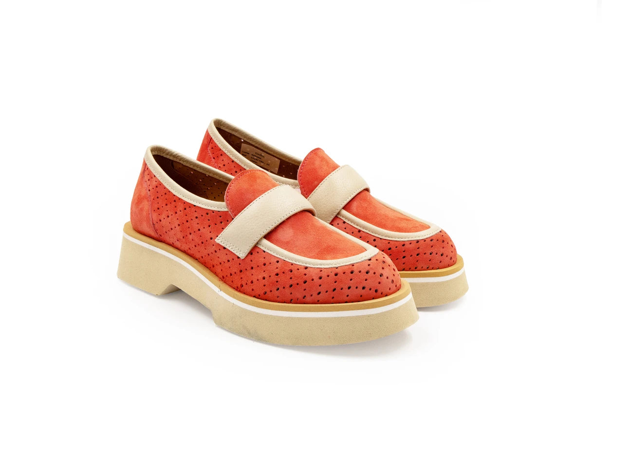A red flat shoe with a white strap and a beige sole, designed for women.