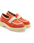 A red flat shoe with a white strap and a beige sole, designed for women.