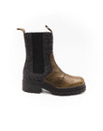 Brown Chelsea boot with black ribbed sock on a white background