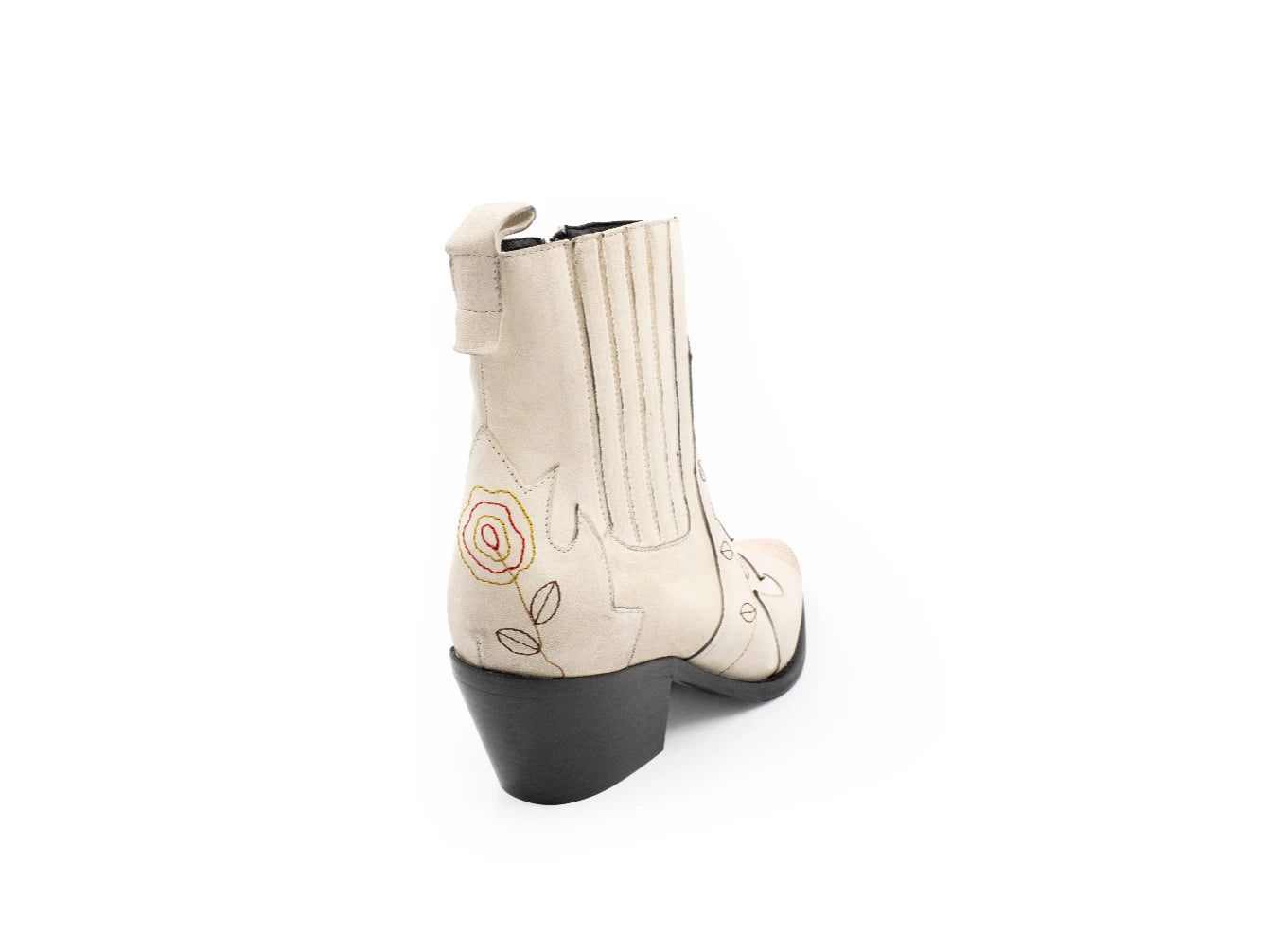 White cowboy boots with black soles on a white background