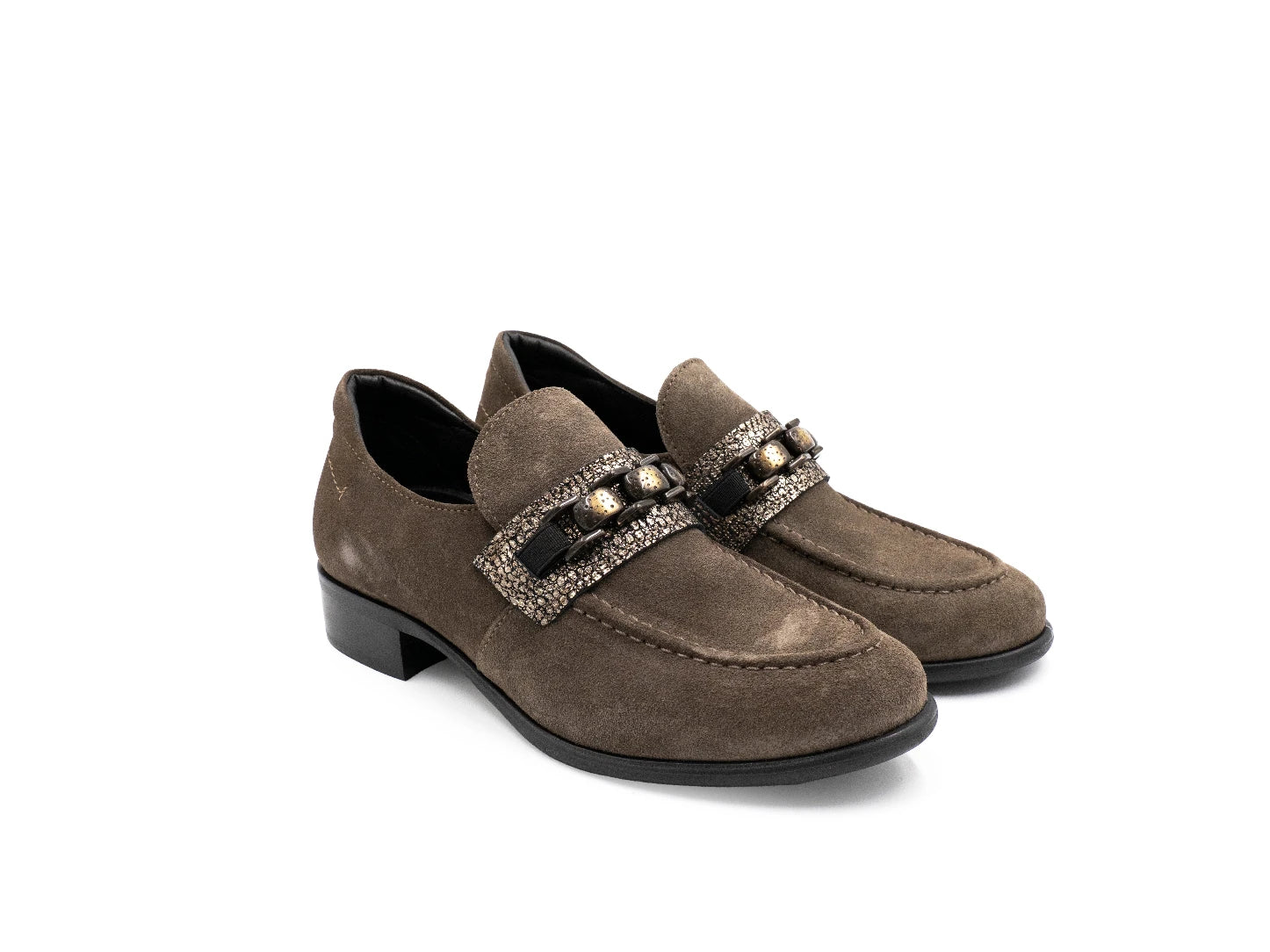 Pair of brown loafers with decorative straps on a white background