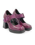 Purple high-heeled shoes with buckles on a white background