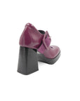 Purple shoes with a black sole on a white background
