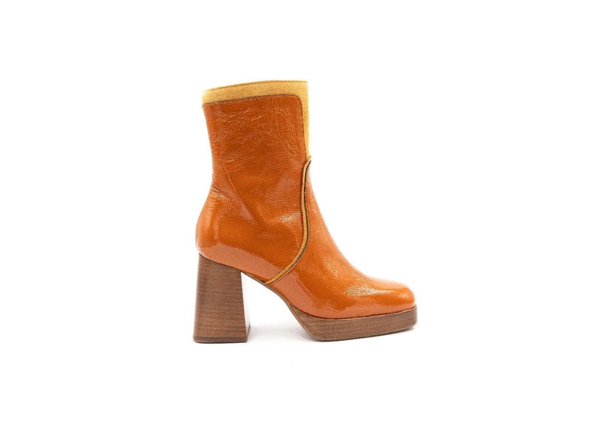 Orange ankle boot with wooden block heel on a white background